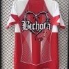 Limited edition red FC Barcelona x Karol G collaboration supporter jersey
